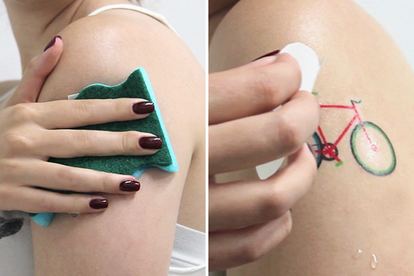 Woman applying custom temporary tattoo