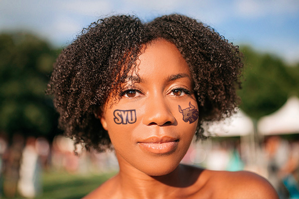Girl with school branded temporary tattoos on her face