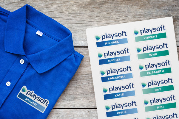 a polo shirt with a name tag iron-on next to a page of iron-on name labels