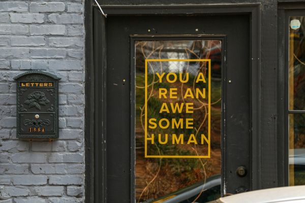 A glass door with vinyl lettering on it.