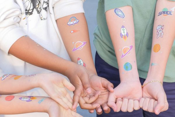 Three people with temporary tattoos on their hands.