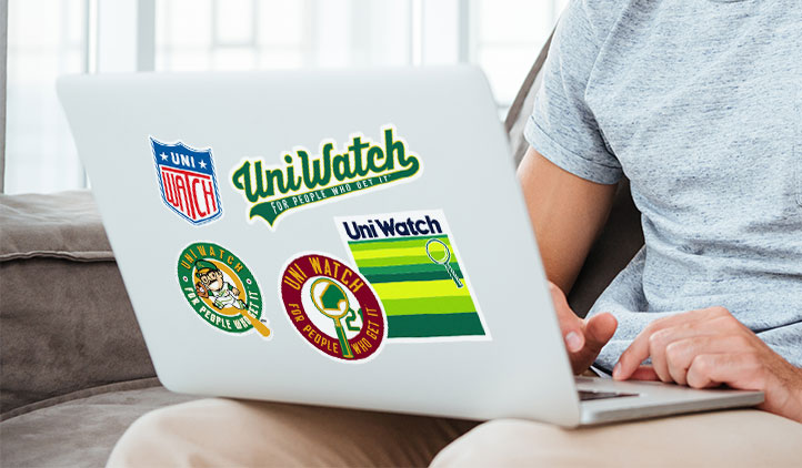 Uni Watch stickers on a laptop
