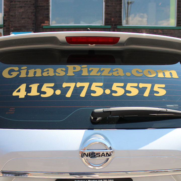 Vinyl window lettering company information on a car